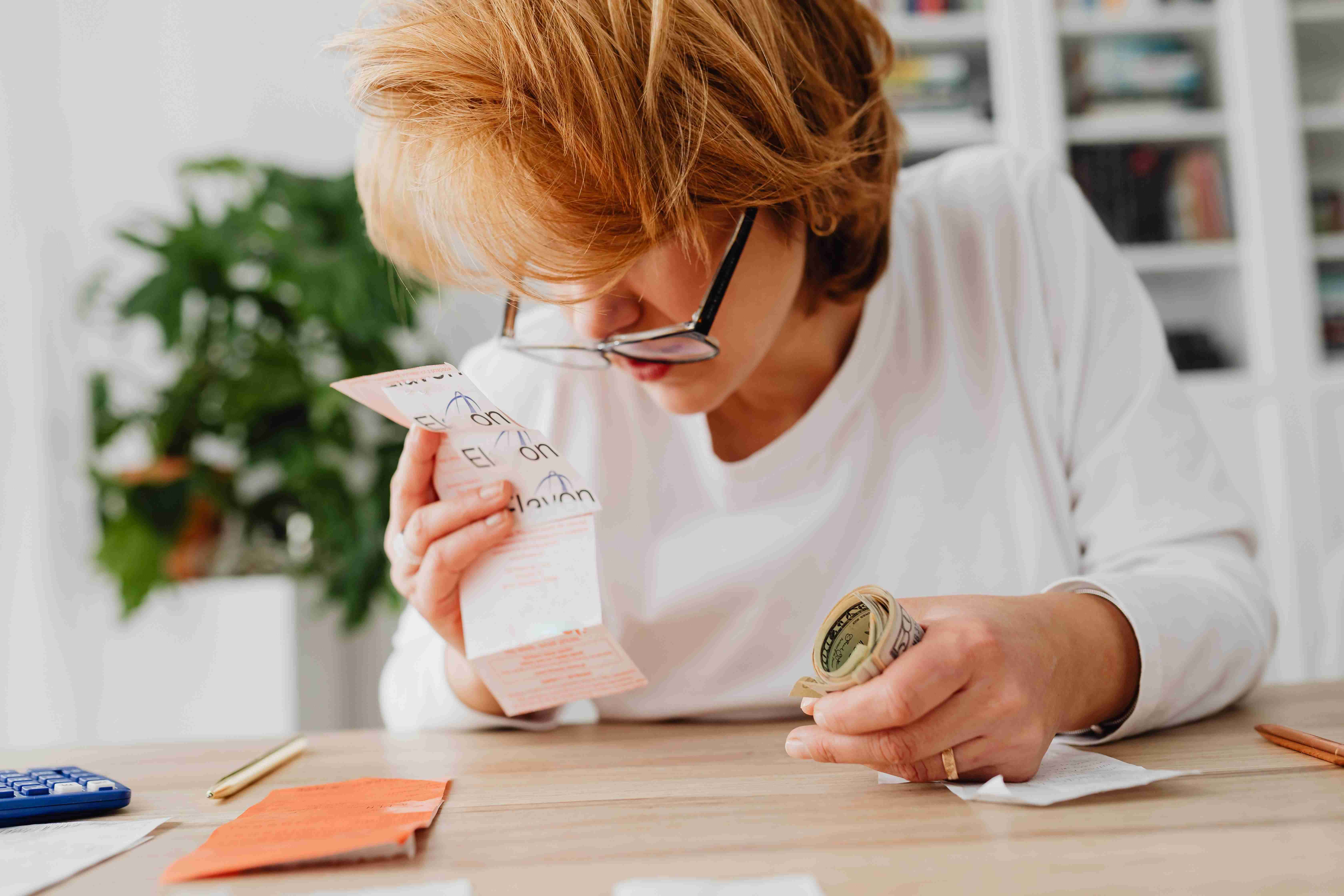 a woman looking at her receipt