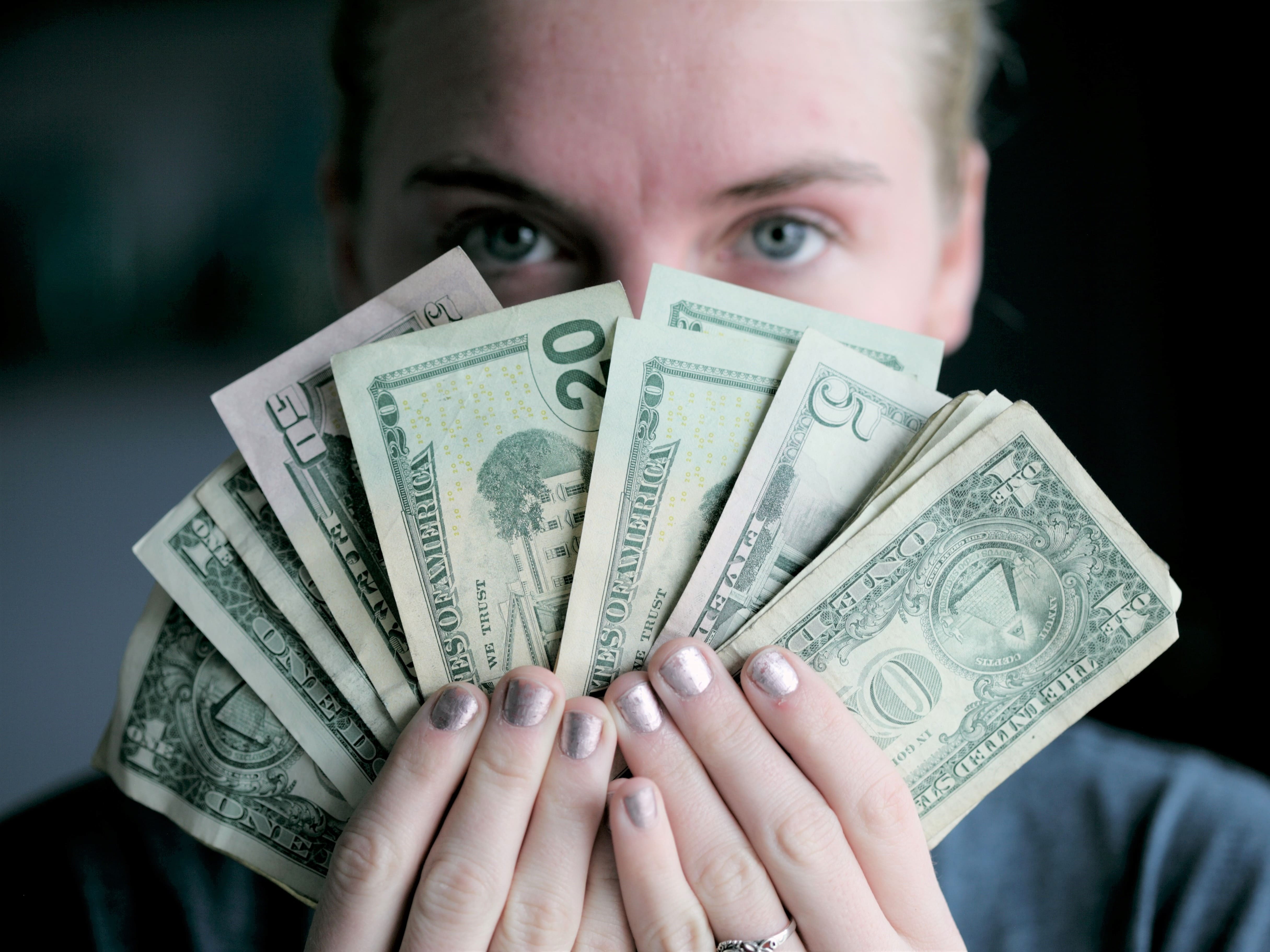 a woman holding cash